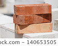 Stack of orange bricks on construction site 140653505