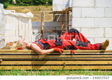 Woman taking break on construction site Woman taking break on construction site 140653507