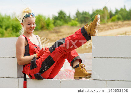 Woman taking break on construction site Woman taking break on construction site 140653508
