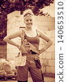 Woman in dungarees working on construction site 140653510