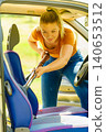 Cleaning car interior with vacuum cleaner 140653512
