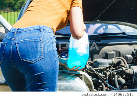 Pouring antifreeze liquid for washing car screen 140653513