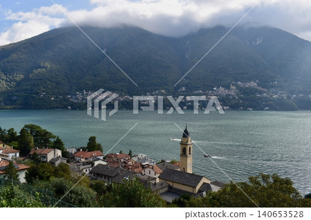 Aerial View of Lake Como, Italy, with Houses, Green Mountains and Clouds on a Sunny Autumn Day Aerial View of Lake Como, Italy, with Houses, Green Mountains and Clouds on a Sunny Autumn Day 140653528