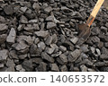 Dark coal litters the ground, coarse and wet 140653572