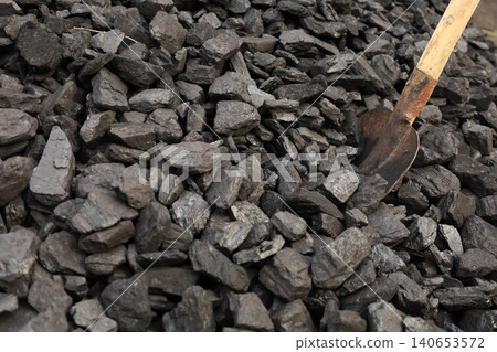 Dark coal litters the ground, coarse and wet Dark coal litters the ground, coarse and wet 140653572