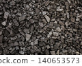 Dark coal piles form a rough mound 140653573