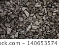 Dark coal piles form a rough mound 140653574