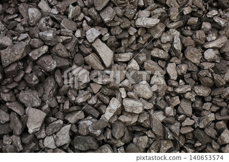 Dark coal piles form a rough mound Dark coal piles form a rough mound 140653574