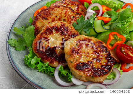 fried chicken cutlets, minced chicken, with vegetables, on gray , with vegetable salad, top view, homemade, no people, 140654108