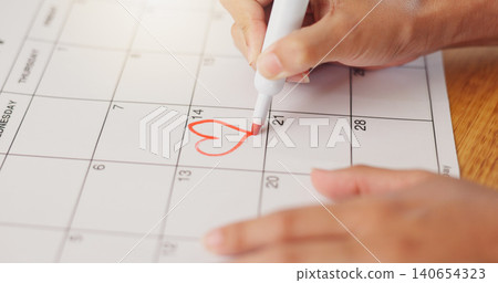 Calendar, hands and save of date for valentines day, commitment and visual reminder for love event. Person, drawing and heart shape to schedule engagement in planner, note and goals for romantic day 140654323