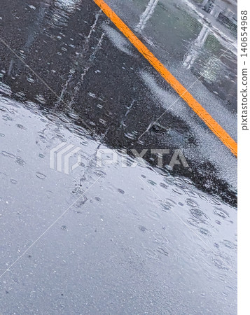 Rain-soaked roads and water ripples / Urban landscape imagery depicting the rainy season and bad weather. Rain-soaked roads and water ripples / Urban landscape imagery depicting the rainy season and bad weather. 140654968
