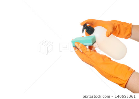 process of applying detergent from a dispenser bottle onto a green sponge in gloved hands process of applying detergent from a dispenser bottle onto a green sponge in gloved hands 140655361
