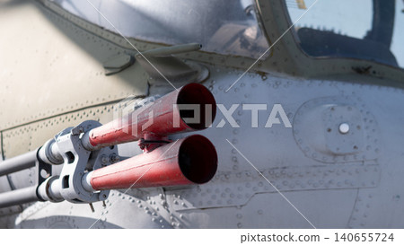 Closeup Rocket Pods On Fuselage, Weathered Paint And Rivets, Three Red Tube Openings, Canopy Edge Visible, Hardpoint Mount And Metal Textures Suggesting Preflight Maintenance Context. Closeup Rocket Pods On Fuselage, Weathered Paint And Rivets, Three Red Tube Openings, Canopy Edge Visible, Hardpoint Mount And Metal Textures Suggesting Preflight Maintenance Context. 140655724