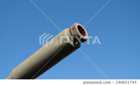 Angled Tank Barrel Muzzle Pointing Into Bright Sky, Visible Bore And Rim, Chipped Paint And Surface Wear, Field Engineer Maintenance Narrative, Outdoor Training Range Vibe Angled Tank Barrel Muzzle Pointing Into Bright Sky, Visible Bore And Rim, Chipped Paint And Surface Wear, Field Engineer Maintenance Narrative, Outdoor Training Range Vibe 140655745