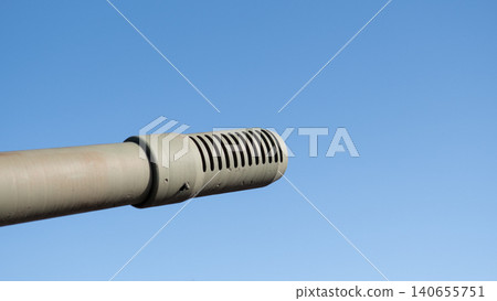 Closeup Cannon Shroud Against Blue Sky, Vented Shroud And Slots Reveal Engineering Update, Camouflage Paint Hints At Field Deployment, Angular Composition Highlights Functional Design Closeup Cannon Shroud Against Blue Sky, Vented Shroud And Slots Reveal Engineering Update, Camouflage Paint Hints At Field Deployment, Angular Composition Highlights Functional Design 140655751