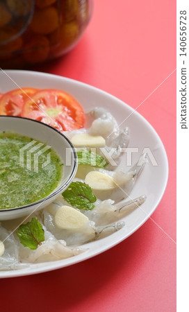 shrimp in fish sauce with Thai spicy seafood dipping sauce on white plate and umeshu 140656728