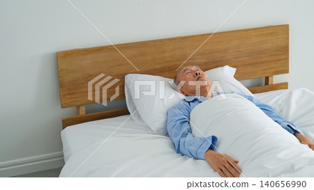 A senior man sleeping soundly in bed. A senior man sleeping soundly in bed. 140656990