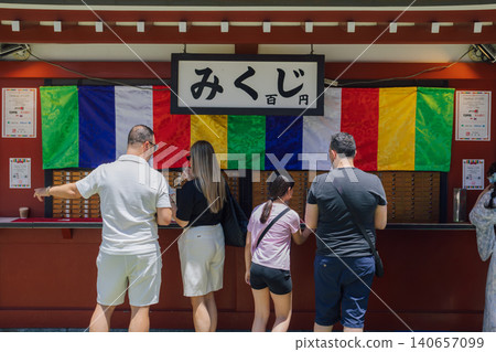 Foreign tourists drawing fortune slips 140657099