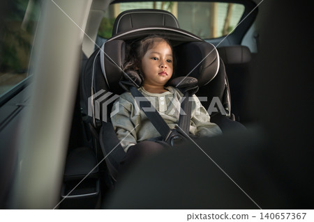preschool child girl sitting in car seat, safety baby chair travelling preschool child girl sitting in car seat, safety baby chair travelling 140657367