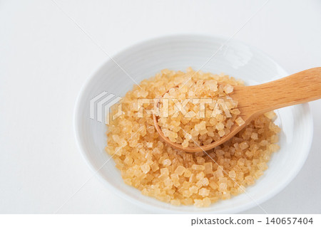 Coarse sugar in a small dish 140657404