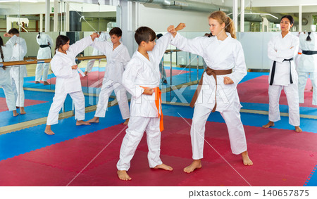 Kids on karate training in gym Kids on karate training in gym 140657875