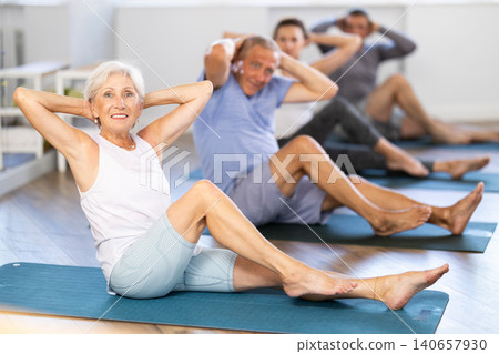 Seniors in sportswear doing exercises at pilates workout Seniors in sportswear doing exercises at pilates workout 140657930