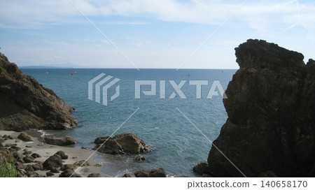People enjoying windsurfing on the calm Sea of Japan in summer. People enjoying windsurfing on the calm Sea of Japan in summer. 140658170
