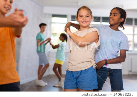 Active preteen children practicing Ballroom dances in pairs in training hall Active preteen children practicing Ballroom dances in pairs in training hall 140658223