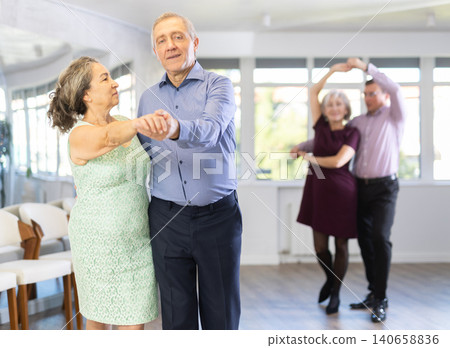 Senior man and elderly woman are dancing classic version of waltz in couple Senior man and elderly woman are dancing classic version of waltz in couple 140658836