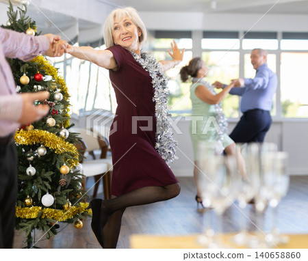 Elderly woman dancing twist with her partner Elderly woman dancing twist with her partner 140658860