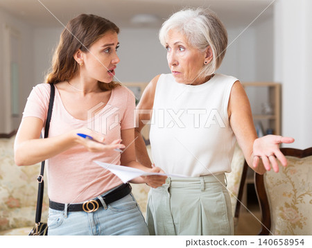 Woman realtor is dissatisfied with the elderly landlady of a rented apartment Woman realtor is dissatisfied with the elderly landlady of a rented apartment 140658954