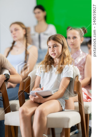 Children and teenagers listening to teacher in classroom Children and teenagers listening to teacher in classroom 140659027