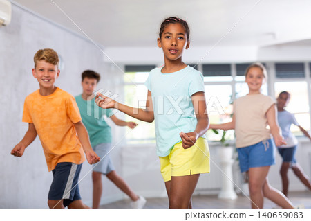 African girl perform choreographic exercises and teach energetic social dance waacking with friends African girl perform choreographic exercises and teach energetic social dance waacking with friends 140659083