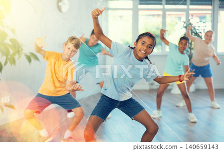 Expressive cheerful african american tween boy practicing hip-hop movements 140659143