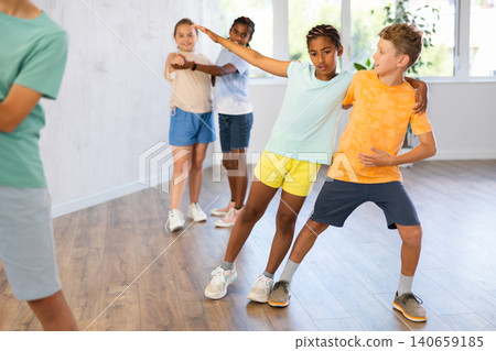 Active preteen children practicing Ballroom dances in pairs in training hall Active preteen children practicing Ballroom dances in pairs in training hall 140659185