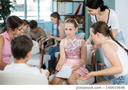 Two groups of children sitting in circle, discussing game tactics. Pioneer leader watch game Two groups of children sitting in circle, discussing game tactics. Pioneer leader watch game 140659696