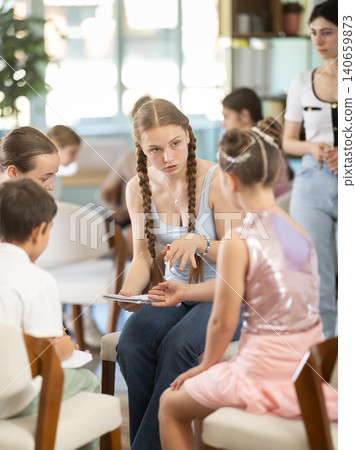 Children have divided into two teams and are discussing tactics of game or competition. Children have divided into two teams and are discussing tactics of game or competition. 140659873