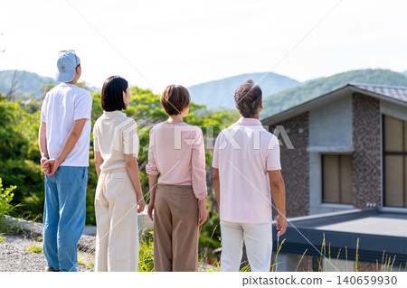 The backs of a two-generation family looking out at the scenery from their vacation home. The backs of a two-generation family looking out at the scenery from their vacation home. 140659930