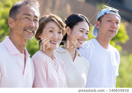 A senior couple and a young couple standing side by side, both smiling. A senior couple and a young couple standing side by side, both smiling. 140659938