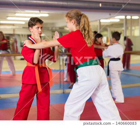 Girl and boy exercising mugendo movements 140660083