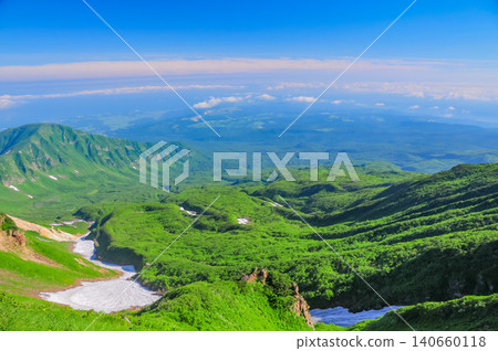 On a clear day after the rainy season, a panoramic view of the vast foothills and the Sea of Japan floating above a sea of clouds can be seen from the descent path of Mount Chokai. On a clear day after the rainy season, a panoramic view of the vast foothills and the Sea of Japan floating above a sea of clouds can be seen from the descent path of Mount Chokai. 140660118