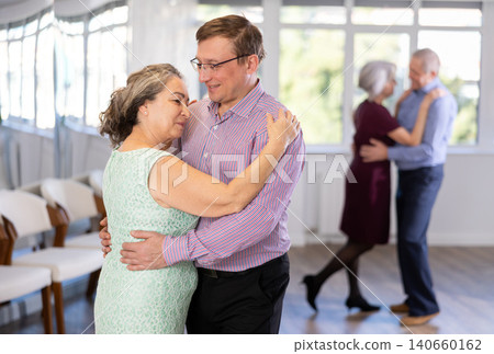 Adult man and elderly woman dance waltz Adult man and elderly woman dance waltz 140660162