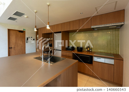 A stylish island kitchen with mosaic tiles. 140660343
