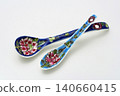 A white background with colorful Peranakan ceramic teaspoons. 140660415