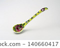 A white background with colorful Peranakan ceramic teaspoons. 140660417