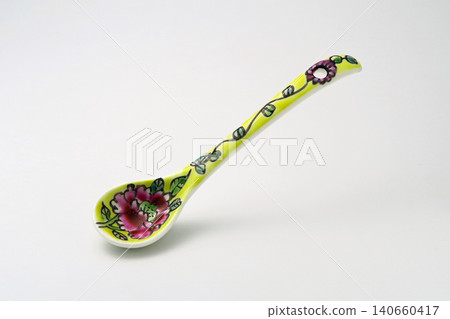 A white background with colorful Peranakan ceramic teaspoons. A white background with colorful Peranakan ceramic teaspoons. 140660417