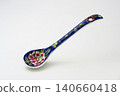 A white background with colorful Peranakan ceramic teaspoons. 140660418