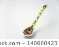 A white background with colorful Peranakan ceramic teaspoons. 140660423
