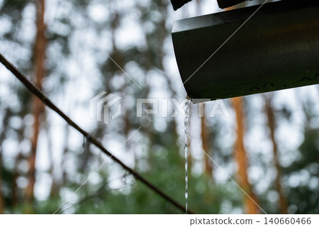 Rainwater Harvesting System Collecting Roof Runoff into Bucket for Sustainable Water Conservation Rainwater Harvesting System Collecting Roof Runoff into Bucket for Sustainable Water Conservation 140660466