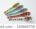 A white background with colorful Peranakan ceramic teaspoons. 140660756